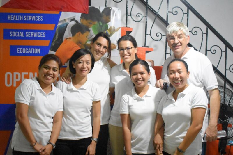 Virlanie team in front of a staircase