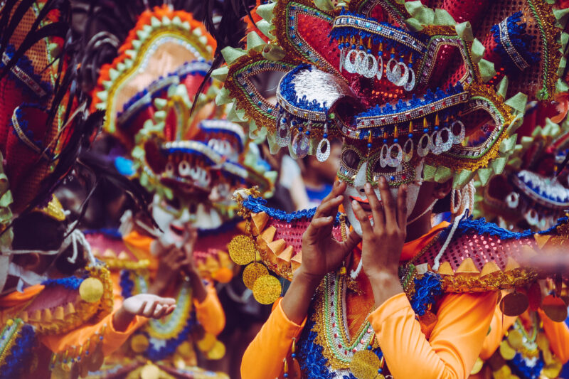 Women wearing colorful dresses and masks