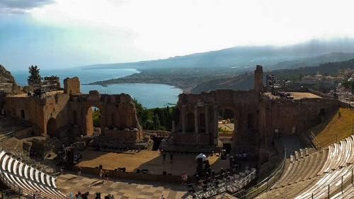 Panoramic view of Teatro Antico, with the sea and Etna in the background