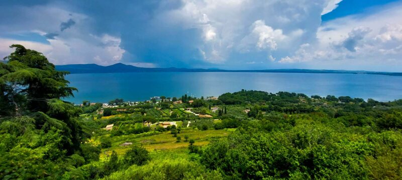 View from Bracciano toward lake Bracciano, which is surrounded by lush green and village houses