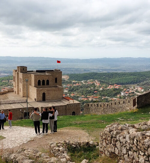 Panoramic view of the Kruja castle and people observing the wide lanscape